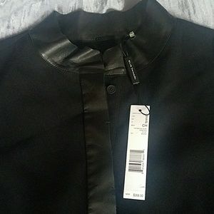 Sleek black blouse,  leather trim